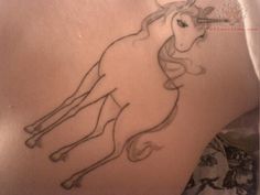 a drawing of a unicorn on the back of a woman's leg