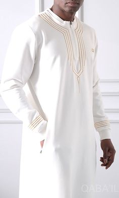 Muslim Men's Embroidered Long Thobe Kamees Sham QL in Cream Description:This Muslim Men's Embroidered Long Thobe Kamees Sham QL in jersey fabric will give you an elegant and simple look. Designed with a matching crocheted embroidery on the neckline and on the sleeves to add a stylish oriental touch. Suitable for any occasion and provides warm and comfort in the cold days. Modern Islamic clothing for men High-quality fabric from top brands Logo on the left chest and two side pockets Stand up coll Modern Islamic Clothing, Top Brands Logo, Brands Logo, Relaxed Trousers, Muslim Men, Simple Look, Cropped Joggers, Stand Up Collar, Islamic Clothing