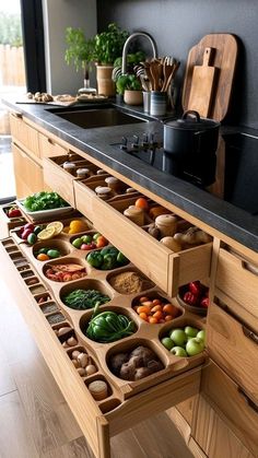 an open drawer in the middle of a kitchen filled with lots of different types of food