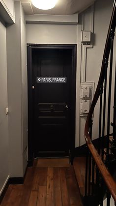 the door to paris france is open and there are stairs in front of it on either side of the door