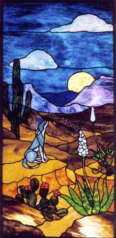 a stained glass window with desert scene in the background