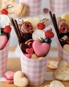 two cups filled with desserts on top of a table