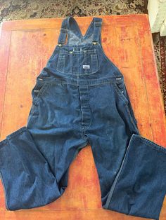 Vintage Blue Denim Bib Overalls  Size Large 42 x 32  See pics for measurements  Quality Big Smith Brand  Made in USA  Perfect slightly faded natural patina with a few bleach stains as pointed out in pics  Fine condition  Quick shipping.  We ship same or next day with USPS MAIL  We are a small family business and we appreciate your purchase, Godspeed ! Big Smith Overalls, Vintage Denim Overalls, Overalls Denim, Overalls Vintage, Vintage Overalls, Salopette Jeans, Jean Bleu, 80s Outfit, Bib Overalls