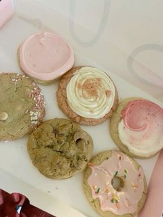 a box filled with lots of different types of cookies and doughnuts on top of each other