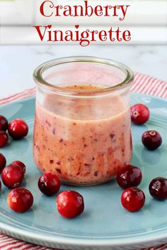 cranberry vinaigrette in a jar with cherries around it