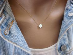 "Elegant, simple, Minimalist This dainty necklace made with a tiny Star of David charm and a delicate gold filled chain. Perfect for everyday wear and layering, this necklace will add a hint of elegance to any outfit. Necklace features: - Opal star of David measures 10 mm - All components are 100% gold filled - Shown at 16\" on the model Gold filled is an actual layer of gold-pressure bonded to another metal. Gold filled is not to be confused with gold plating as filled literally has 100% more g Simple White Clavicle Chain Charm Necklace, Minimalist Star Of David Necklace For Everyday, Simple Tiny White Necklace, Magen David Necklace, Star Of David Necklace, Necklace Opal, Jewish Jewelry, Tiny Star, Ball Necklace