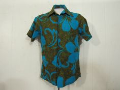 "Vintage 1960s op art Hawaiian shirt. Made of cotton. Color is electric blue and green/brown with hibiscus flowers like Warhol's poppies. Shirt has a button front, top button loop and single matching pattern chest pocket. Made by Hawaiian Casuals. Made in Hawaii. Size small. Measurements are: 39\" at the chest 39\" at the waist 15.5\" shoulder seam to shoulder seam 28\" overall length In very good condition." Hawaiian Vintage, Matching Patterns, Vintage Hawaiian Shirts, Art Shirt, Vintage Hawaiian, Flower Shirt, Art Shirts, Op Art, Green And Brown