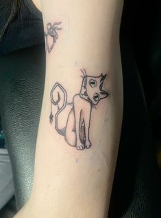 a small cat tattoo on the left arm and leg, it is black and white