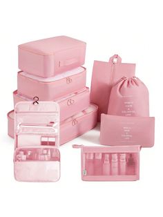 several pink suitcases are stacked on top of each other with their lids open and the contents packed