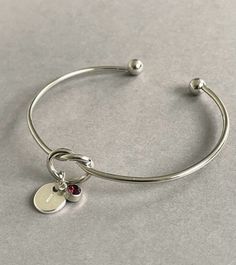 Pretty silver initial amethyst birthstone bracelet bangle - an ideal personalised gift for a loved one or would make a lovely personalised gift for a Bridesmaid. A gift note can be added (any text can be written) just remember to add the note in the 'personalisation box'. + Bangle is adjustable so will fit most girls and women (to tighten the bangle gently squeeze it to make it smaller) + Silver plated bangle + Silver plated initial charm + Silver plated birthstone charm + Disc initial charm mea