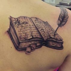 an open book with a feather on it and the word shanna written in cursive ink