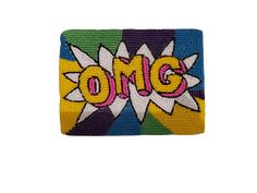 an embroidered patch with the word omg in comic style letters on yellow and blue background