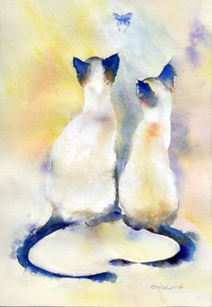 two siamese cats sitting on top of a white object with a butterfly flying above them