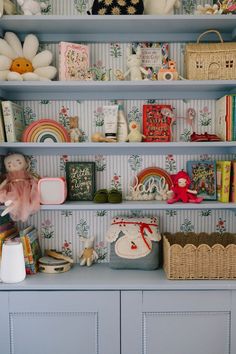 the shelves are filled with toys and other items on top of each shelf in this children's room