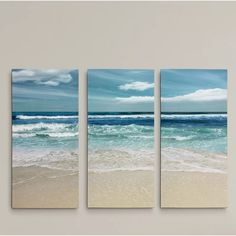 three paintings on the wall of a beach with waves crashing in to shore and blue sky above