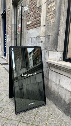 a sign on the sidewalk that says treat yourself