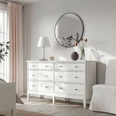 a white dresser and mirror in a room