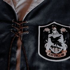 the ravenclaw crest is attached to a jacket