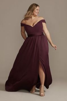 a woman in a long dress posing for the camera