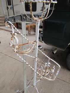 a metal pole with chains attached to it and a dog standing next to the truck