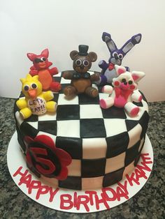 a birthday cake decorated with five cartoon characters