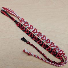 three braided lanyards sitting on top of a wooden table