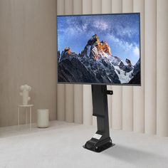 a flat screen tv sitting on top of a stand in front of a white wall