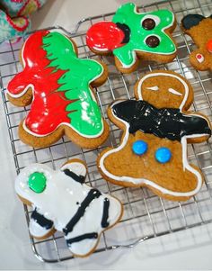 several decorated cookies sitting on a cooling rack