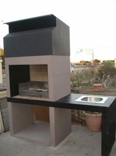 an outdoor oven with a sink on the outside