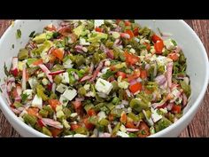 a white bowl filled with chopped vegetables on top of a wooden table