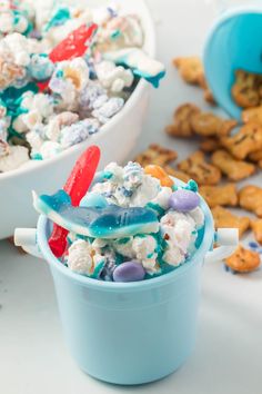 two buckets filled with popcorn and candy