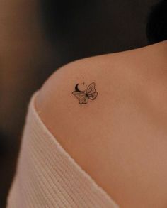 a woman with a butterfly tattoo on her shoulder