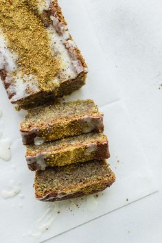 four slices of cake sitting on top of a piece of parchment paper with sprinkles