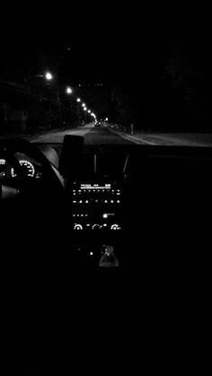 the interior of a car at night with its lights on and dashboard light turned on