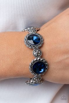 An oversized blue rhinestone adorns the center of a hematite rhinestone petaled floral frame. Infused with hematite dotted silver accents, the glitzy floral frames sparkle along stretchy bands around the wrist for a glamorous finish.

Sold as one individual bracelet. Floral Frames, Floral Frame, Paparazzi Accessories, Matching Accessories, Rhinestone Bracelet, Colourful Necklace, Paparazzi Jewelry, Pink Bracelet, Colorful Bracelets