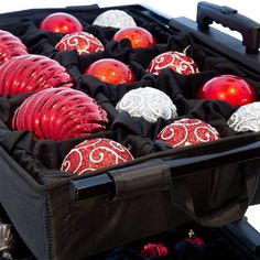 an open suitcase filled with red and silver ornaments