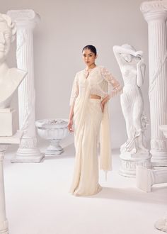 Our rich craftsmanship adorn the jacket. The organza saree has scallops on all the corners of the drape, paired with an organza plunge neckline sleeveless blouse. Get ready to make a statement with this effortless silhouette, delicate embroidery and the soothing hue. Colour: Off- White Material: Net- Jacket, Organza- Saree, Organza- Blouse No of components: 3 Surface Ornamentation: Hand Embroidery Care Instructions: Dry Clean Shipping Time: 3-4 weeks Jacket Saree, Net Jacket, Surface Ornamentation, Saree Organza, Shirt Jacket Men, Organza Blouse, Drape Saree, Delicate Embroidery, Organza Saree