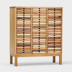 a wooden cabinet with many drawers on it