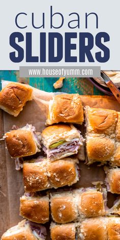 a pile of sliders sitting on top of a cutting board next to a knife