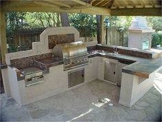 an outdoor kitchen with stainless steel appliances