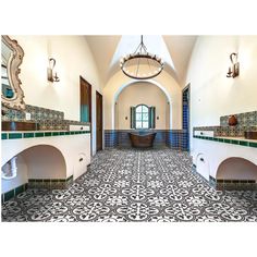 an ornate bathroom with blue and white tiles on the floor, two sinks, and a bathtub