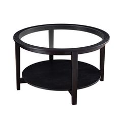 a round glass table with two shelves on each side and one shelf below the coffee table