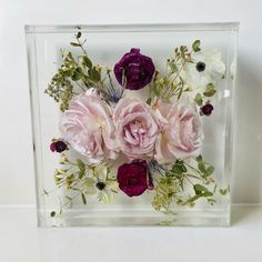 10 x 10 inch crystal clear epoxy resin square. Holding three pink Roses, dark burgundy rannaculus, wax flower and delicate Queen Anne’s lace. This wedding bouquet has been preserved into a lifetime keepsake. Flower Bouquet Resin Block, Bridal Bouquet Resin Preservation, Preserving Roses In Resin, Resin Blocks With Flowers, Preserve Wedding Bouquet Resin, Resin Flowers Wedding, Preserve Flowers In Epoxy Resin, Bouquet Resin Preservation, Bouquet Preservation Resin