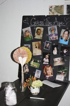 a black table topped with pictures and a fan next to a vase filled with flowers