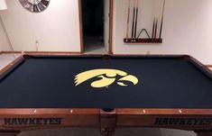 a pool table with the university of iowa logo on it