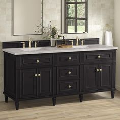 a bathroom vanity with two sinks and mirrors