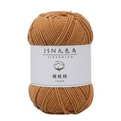 an orange ball of yarn with chinese writing on the front and bottom, it is brown