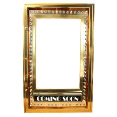 a gold frame with the words coming soon on it and beaded trim around the edges