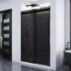 a modern bathroom with black and white accents, including a large bathtub next to the shower