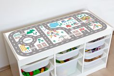 a toy table with bins and toys on it